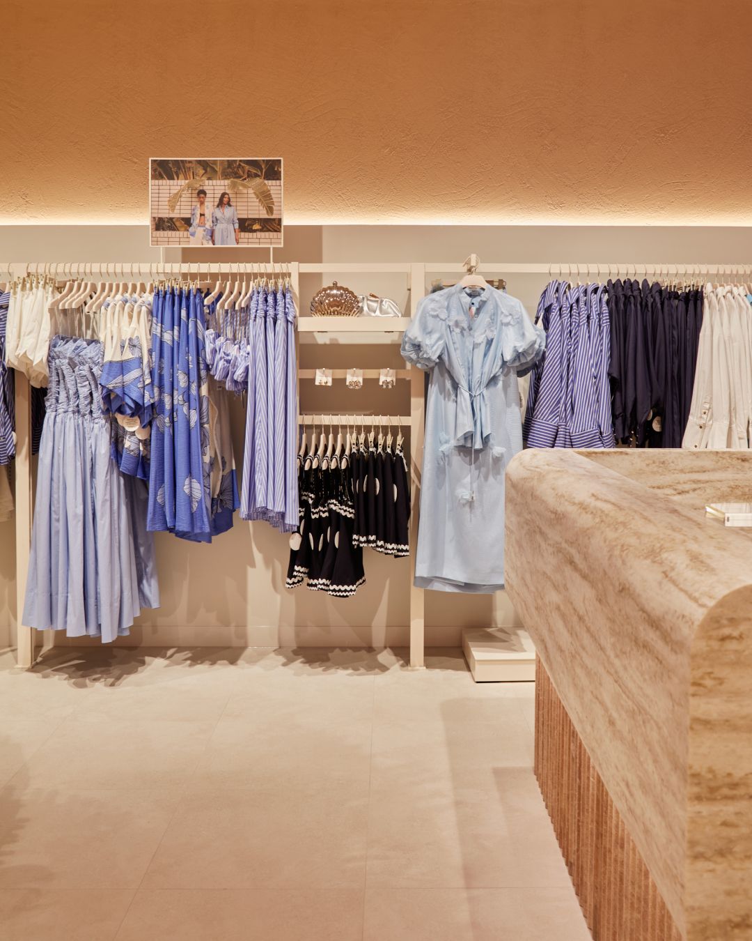 Store interior — pastel range against a travertine counter